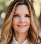 A headshot-style picture of a woman smiling