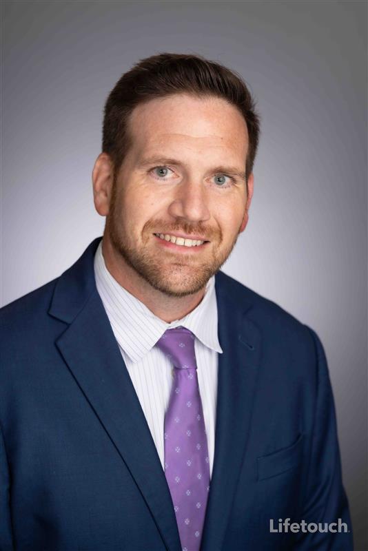 Tony Schlorff Member Spotlight A man in a suit smiling