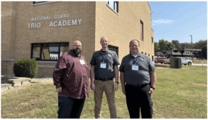 High school educators at National Guard Trios Academy promoting education and cybersecurity.