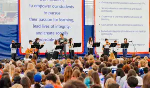 Children performing on stage at a school event promoting student empowerment and integrity.