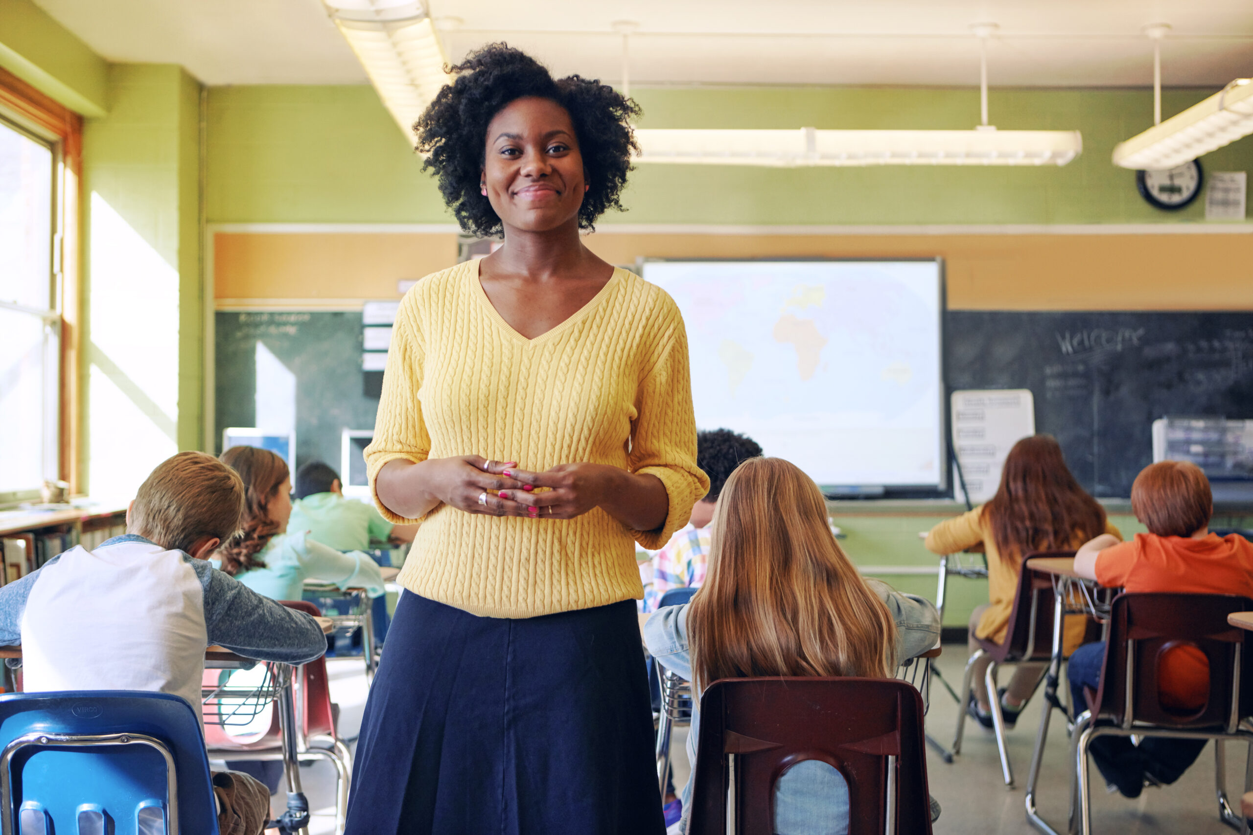 portrait, teacher and black woman with students learning in classroom. education, scholarship and happy, proud and young female educator with children ready for studying or knowledge in middle school